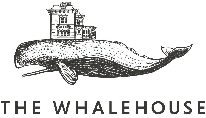 Logo for The Whalehouse. Shows a line drawing of a whale with a house on top of it.